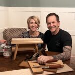 A picture of Lisa and Gordon Addison with a Amish style step stool, woodworking tools, and paint