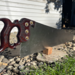 Picture of a Dennis Wayne panel saw with a rosewood wheat carved handle