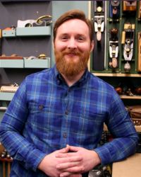 Eric Meyer in his woodworking shop standing in front of hand tools