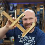 James Wright - Wood By Wright- holding a hand made wooden Luthier Clamp