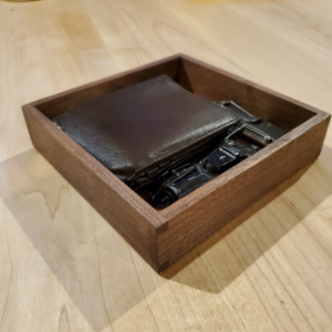 Hand made wooden catch all valet tray made out of walnut with a wallet inside