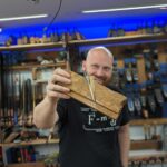 Photo of James Wright holding a wooden Grooving plane