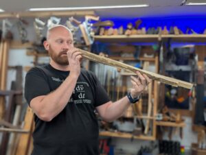 Plane Wellness Course picture of James Wright holding a twisted board