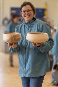 Elizabeth Weber holding two turned bowls