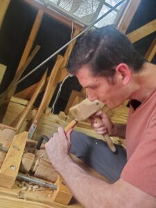 Ryan Barnard using a woodworking chisel