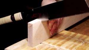 Picture of a Japanese Pull Saw cutting a board