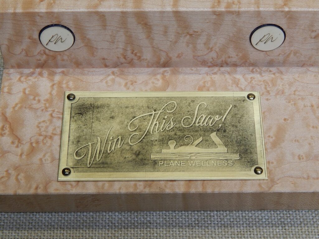 Picture of a Loon Lake Tool Works Saw Stand stating Win This Saw and the Plane Wellness Logo Donated by Just Plane Fun