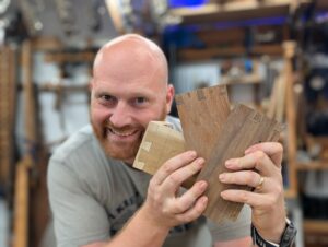 James Wright holding practice dovetail pieces