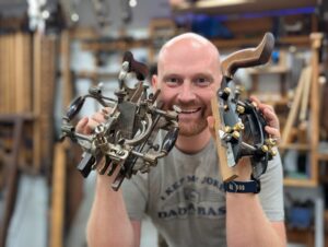 James Wright holding a Vintage Stanley no 55 and a Veritas Combination Plane